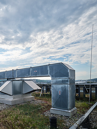Photo of a man removing a cover from a ventilation system