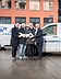 STRABAG PFS Triburuzek Picture of four persons holding a big key in front of a building and two cars