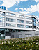Photo of a wide glass building with letters ´MAHLE´