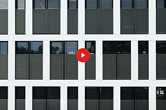 Preview image of a video: External blinds on an office building are halfway up the windows