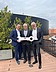Handing over the keys from Instalace Praha Photo of three men on a balcony holding a large key