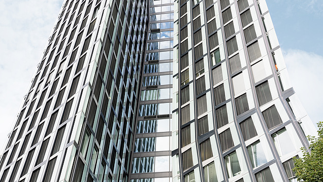 Smiling woman hands a key to a man.