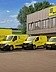 With the acquisition of ELCO, STRABAG PFS is expanding into Luxembourg. Photo of a fleet of yellow vehicles in front of a building