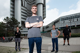 Groups of service staff in front of a building managed by STRABAG PFS