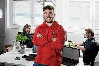 Trainee in an office room together with two colleagues
