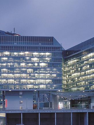 Photo of an illuminated glass building at dusk