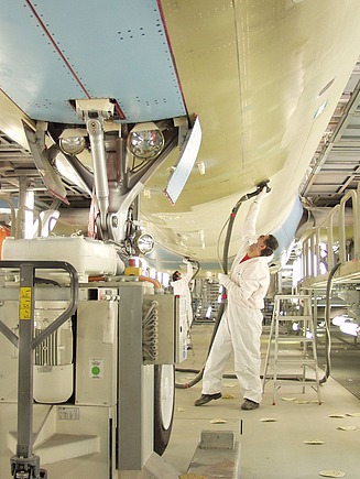 Picture of a person polishing the outside of an airplane