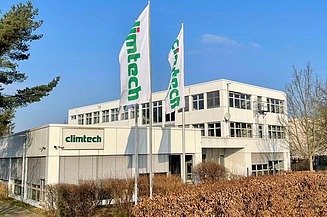 STRABAG PFS Climtech Photo of a small building with the letters climtech and two flags in front of the building