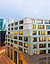 Objekt Union Investment Karlstraße in Frankfurt Foto von einem sechstöckigen Gebäude an einer Kreuzung, im Hintergrund ein paar Hochhäuser