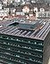 Aerial view of a tall building on which the roof is completely covered with PV systems